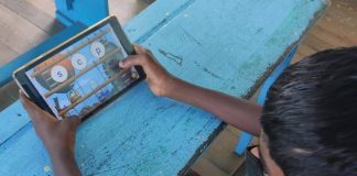 Lille dreng spiller på læringsapp i skolen for at blive bedre til at læse