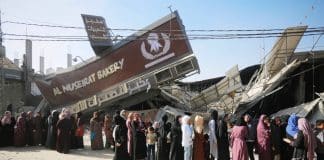 People standing in line in front of a bakery in Gaza