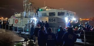 IOM Libya staff assist migrants at a disembarkation point in Tripoli, Libya.
