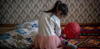 A five-year-old girl plays in her family's apartment in Kazakhstan, where UNICEF is working to eliminate domestic violence through home visits.