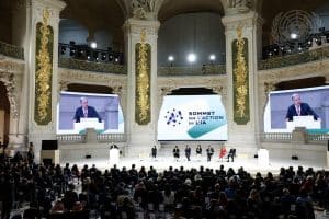 Secretary-General António Guterres (left at podium and on screens) addresses the Artificial Intelligence Action Summit in Paris, France.