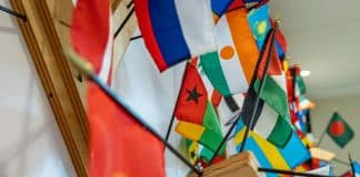 Μικρού μεγέθους σημαίες από διάφορες χώρες του κόσμου, κρεμασμένες στον τοίχο.
