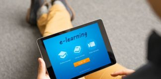 Person holding tablet with e-learning website
