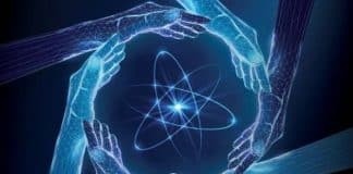 Image of an atom surrounded by hands