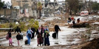 UNRWA. Displaced people walk from the north of Gaza towards the south, as ambulances head in the other direction.