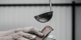 adding soup to a bowl held by an elderly person