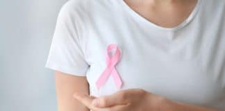 Breast Cancer Awareness - a women in a white t-shirt with a pink ribbon