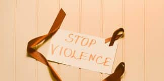 Stop Violence written on paper with ribbon