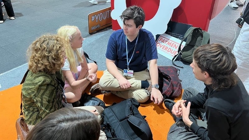 Benjamin van Bunderen Robberechts sitting with other activists
