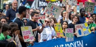 © ICJ-CIJ/Frank van Beek Climate activists react to the advisory opinion of the International Court of Justice (ICJ) in front of the Court’s headquarters in The Hague.