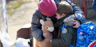 A child holding another child
