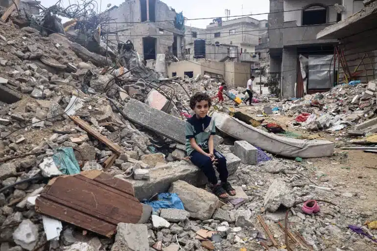 A child sitting in rubble