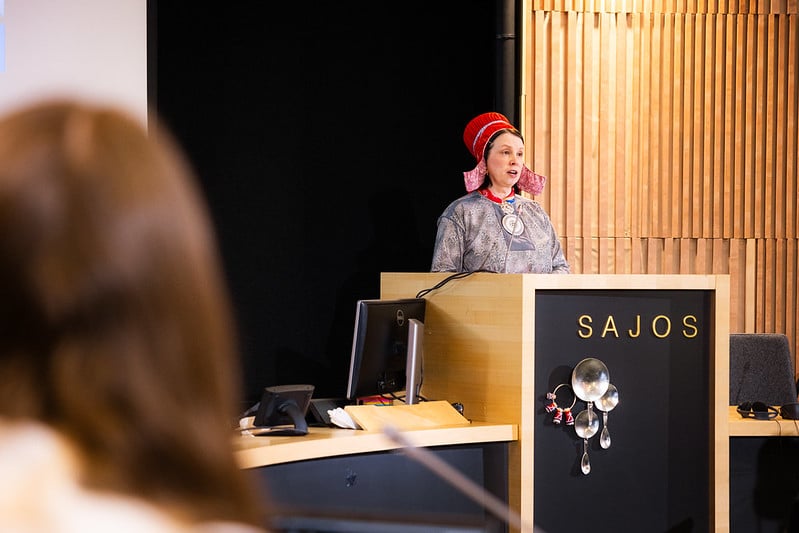 A woman speaking in a formal setting