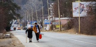 Mila Volodymyrivna Khalova, Kyiv, with assistance from a volunteer, heads to the Slovak border