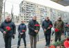 High Commissioner Filippo Grandi (centre), alongside representatives of local authorities, lays flowers at a residential building that was destroyed during a missile strike on 14 January 2023, in Dnipro city, Ukraine