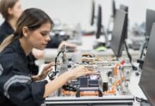 Mechatronics technician assembling parts