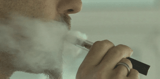 En man som röker en e-cigarett